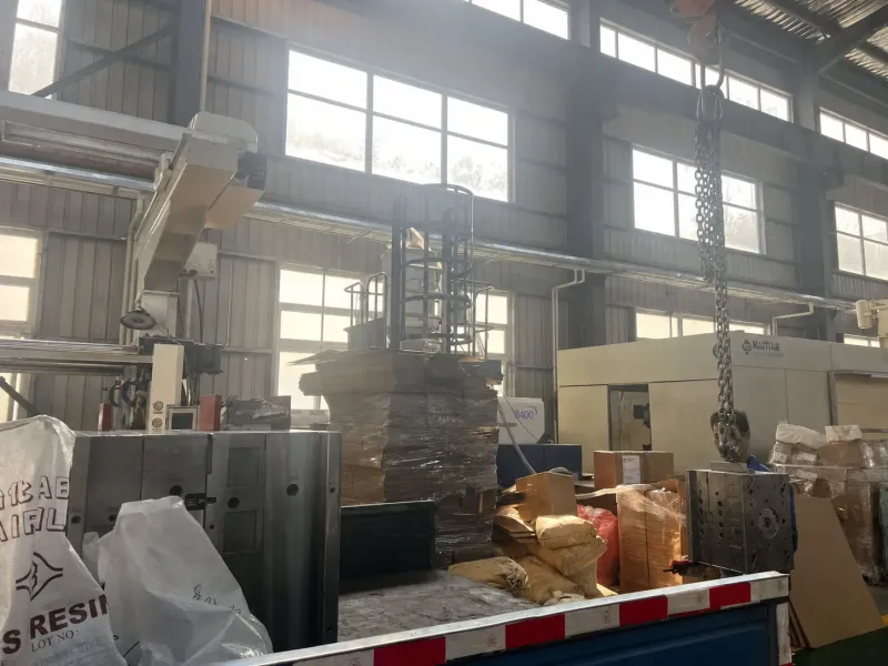 injection molding machine and raw resin bags on an injection molding factory floor